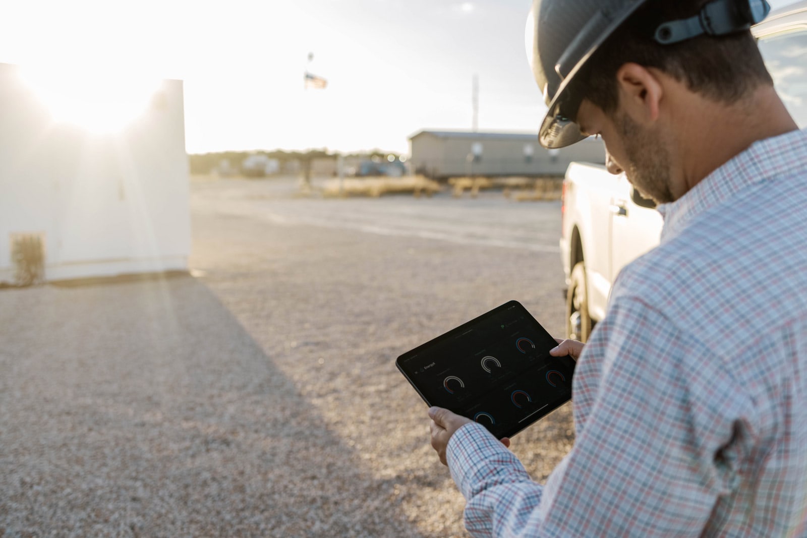 Trevin Vaughn holding tablet displaying status of EnergyX equipment